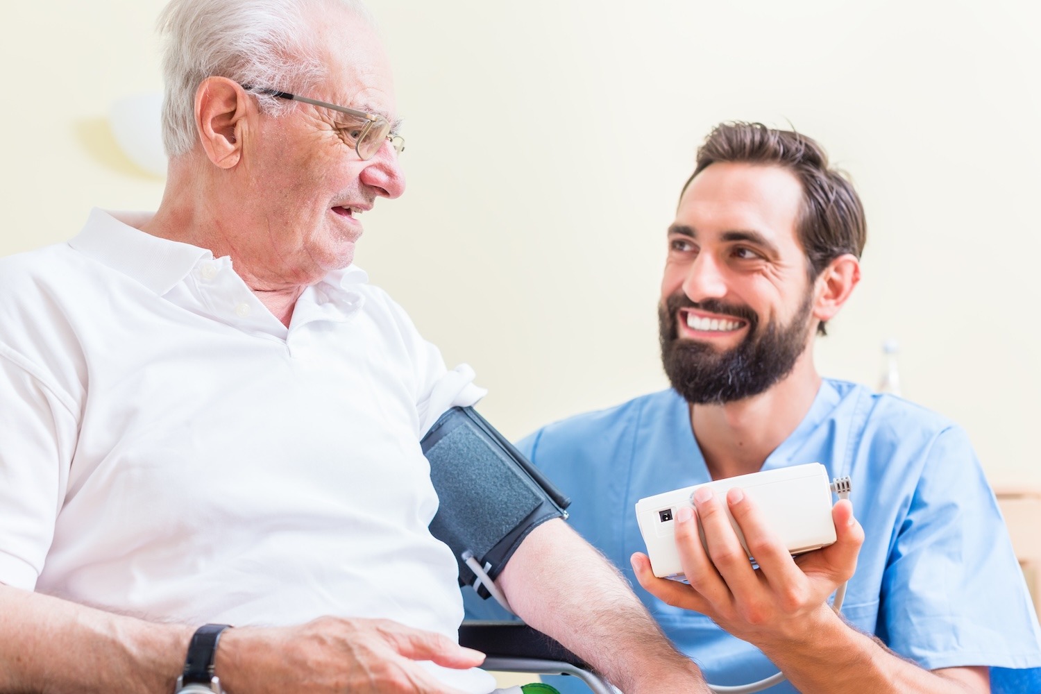 Nurse measuring blood pressure of senior patient